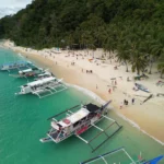 White sand Seven Commando Beach El Nido Philippines turquoise water palm trees