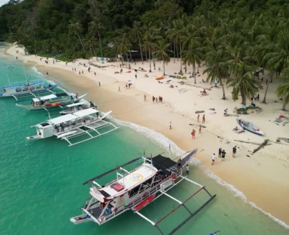 White sand Seven Commando Beach El Nido Philippines turquoise water palm trees