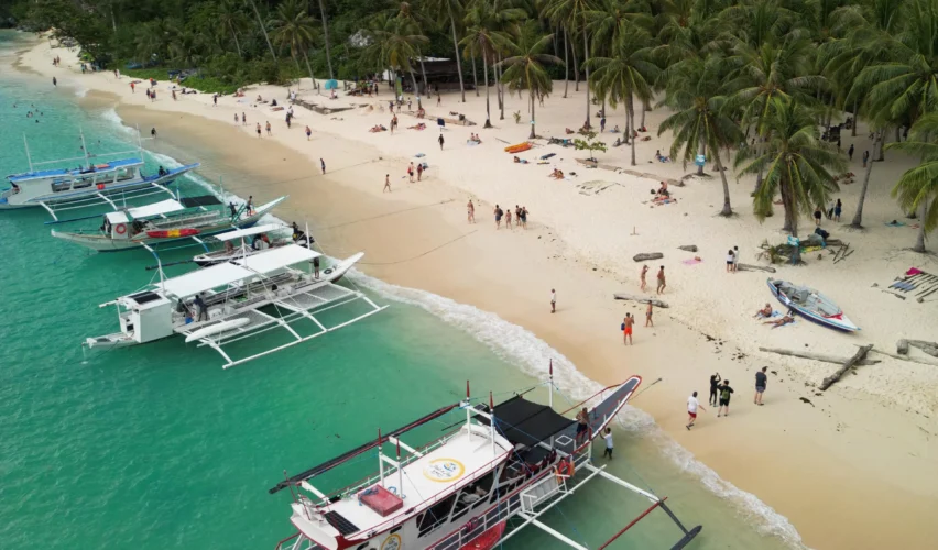 White sand Seven Commando Beach El Nido Philippines turquoise water palm trees